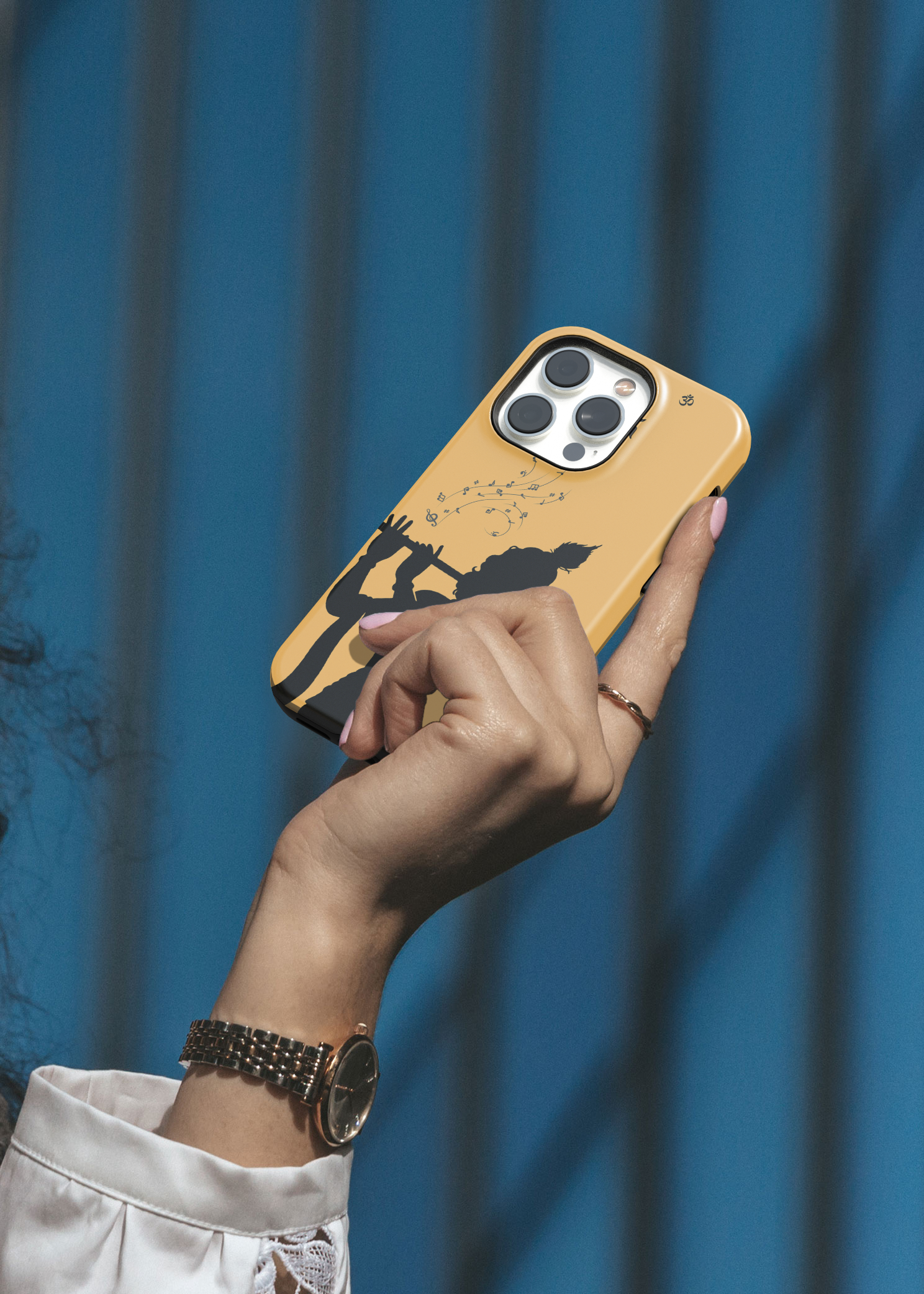 Hand holding a phone with a yellow case against a blue background